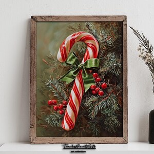 May include: A framed print of a candy cane with red and white stripes, decorated with a green bow and red berries, set against evergreen branches. The artwork is in a rustic wooden frame.
