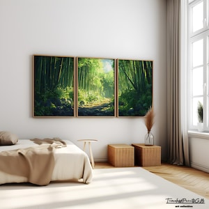 May include: A triptych of framed art prints depicting a bamboo forest path bathed in sunlight. The artwork features lush green bamboo stalks and a pathway leading into the distance. The frames are a warm, natural wood tone, complementing the serene forest scene.