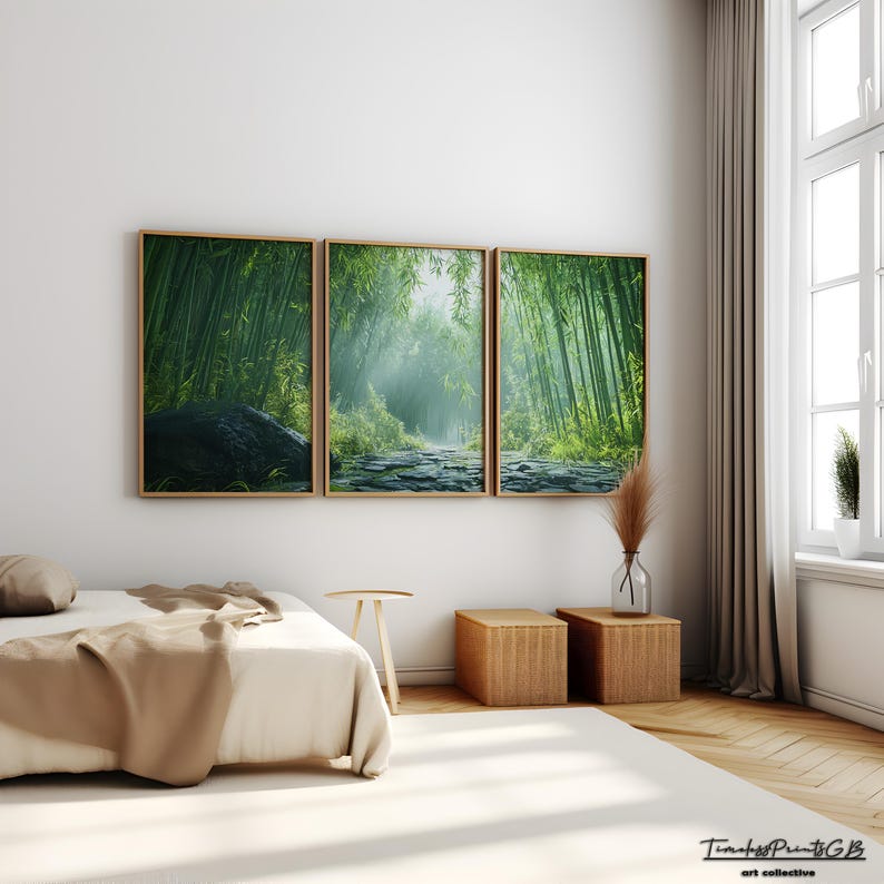 May include: A three-piece set of framed prints depicting a lush green bamboo forest with a path leading through it. The prints are hung on a white wall in a bedroom setting with a bed, side tables, and a window.