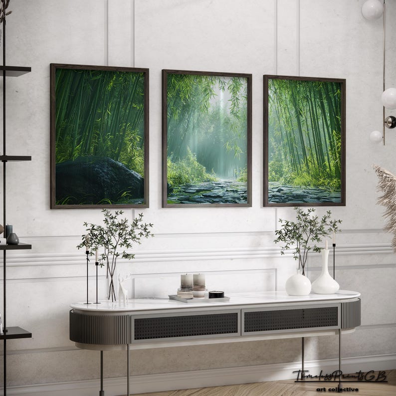 May include: Three framed prints of a misty green bamboo forest with a path leading through the center. The prints are hung on a white wall above a modern console table.