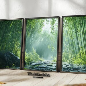 May include: Three framed prints of a lush green bamboo forest with a stone path leading through the center. The prints are in black frames and are hung on a white wall.
