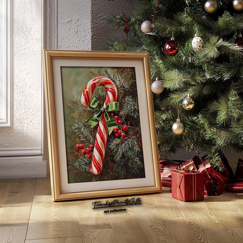 May include: A framed print featuring a candy cane with a green bow and red berries, set against evergreen branches. The artwork is in a gold frame, with a Christmas tree and wrapped gifts in the background. The text "Timeless Prints GB art collective" is at the bottom.