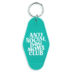May include: Teal blue motel key chain with the text "Anti Social Dog Moms Club" in white.