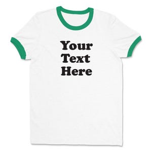 May include: White t-shirt with a green ringer and the text "Your Text Here" printed in black.