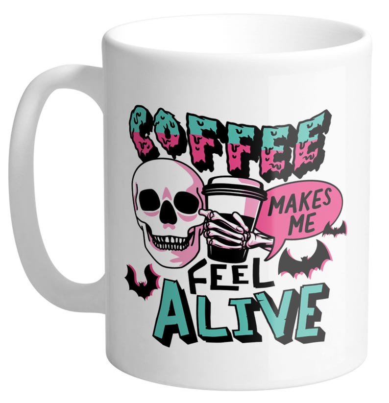 May include: White ceramic coffee mug with a black handle featuring a skull graphic and the text "COFFEE MAKES ME FEEL ALIVE" in teal, pink, and black. Includes a coffee cup and bat illustrations.