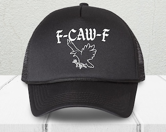May include: Black trucker hat with a white graphic of a raven and the text "F-CAW-F". The hat has a mesh back and a curved brim. The text and graphic are centered on the front of the hat.