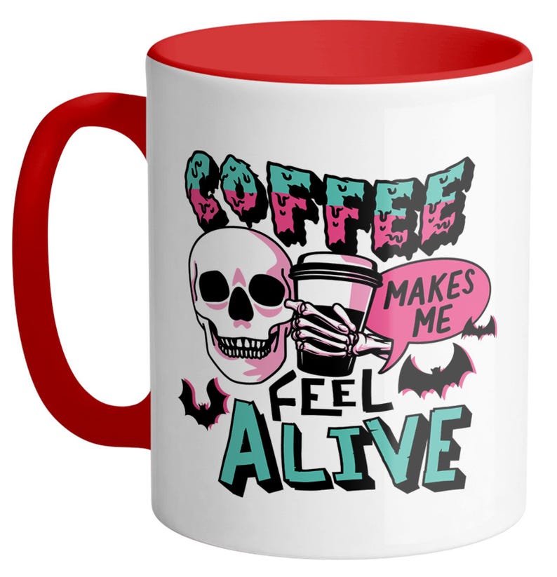 May include: White ceramic coffee mug with a red handle and interior. The mug features a skull graphic holding a coffee cup, with the words "COFFEE MAKES ME FEEL ALIVE" in a spooky font. Bats are also included in the design.