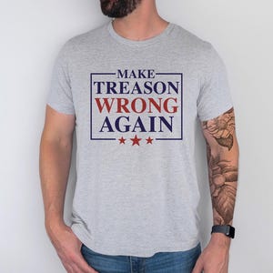 May include: A gray t-shirt with the text "MAKE TREASON WRONG AGAIN" in a blue and red box with three red stars below the text.