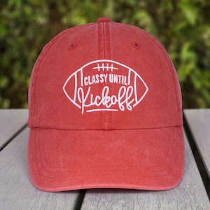 May include: Red baseball cap with white embroidery of a football and the text "Classy Until Kickoff".