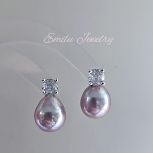 May include: A pair of silver earrings with a teardrop-shaped pearl and a small, clear cubic zirconia stone.