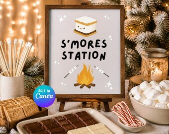 May include: A framed sign with a dark wood border featuring the text S'MORES STATION in black letters. The graphic includes a smiling marshmallow, a campfire, and two roasting sticks with marshmallows on a light gray background.