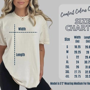 May include: Cream-colored t-shirt with a size chart and the text "Comfort Colors C1717". The size chart shows the width and length in inches for sizes S to 4XL. The model is wearing a medium.