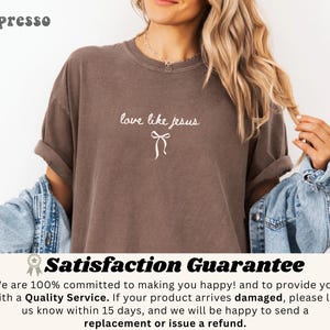 May include: Espresso-colored t-shirt with the phrase "love like jesus" in white script and a bow graphic. The shirt is a relaxed fit and has rolled-up sleeves. The word "Espresso" is printed in the upper left corner.
