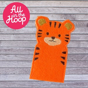 May include: Orange felt finger puppet of a tiger with black stripes and gold ears. The tiger has a stitched-on face with black eyes, a black nose, and a gold mouth.