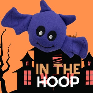 May include: Purple plush bat with a smiling face and the text "In the Hoop" in front of a black silhouette of a house.