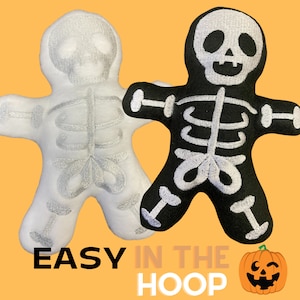 May include: Two embroidered skeleton plush toys, one white and one black, with the text "EASY IN THE HOOP" and a cartoon pumpkin with a mischievous grin.