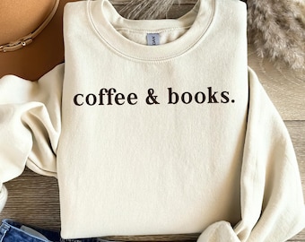 May include: A cream-colored sweatshirt with the text "coffee & books." printed in black on the front.