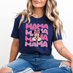 May include: A navy blue t-shirt with a pink and white graphic of Minnie Mouse wearing sunglasses and the word "MAMA" repeated four times.