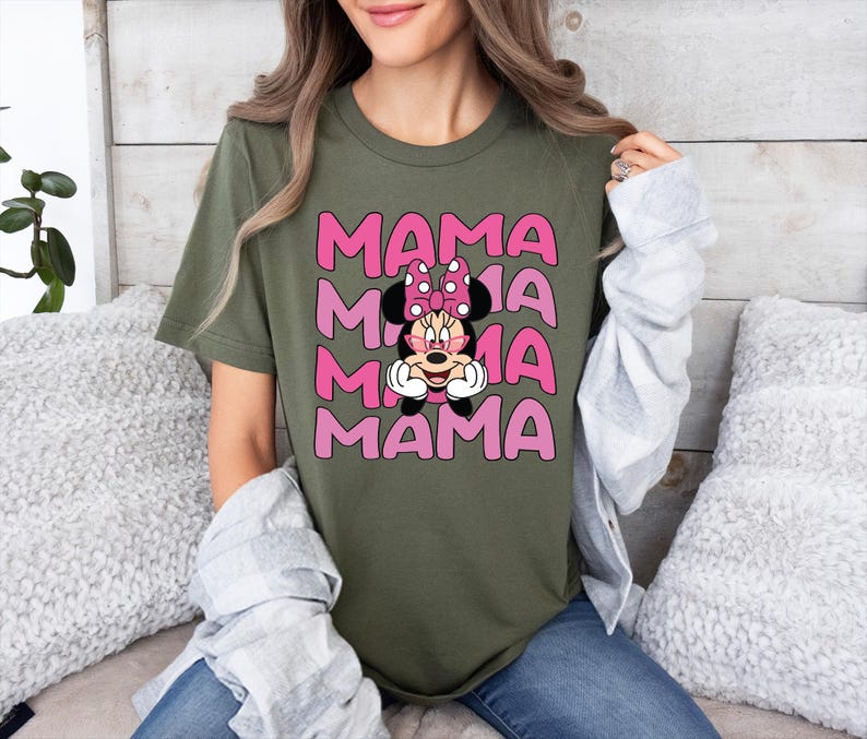 May include: A green t-shirt with a pink graphic of Mickey Mouse's girlfriend Minnie Mouse with the word "MAMA" repeated four times.