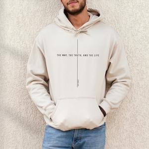 May include: A beige hoodie with a black vertical line and the text "THE WAY, THE TRUTH, AND THE LIFE" and "JOHN 14:6" printed on the front.
