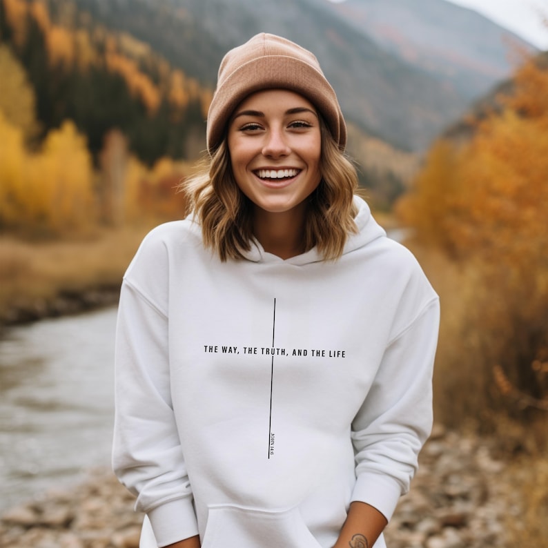 May include: White hoodie with a black cross and the text "The way, the truth, and the life" with the scripture reference "John 14:6".