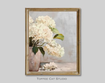 May include: A framed painting of a bouquet of white hydrangeas in a pale pink vase. The flowers are arranged in a loose, natural style, and the background is a soft, muted gray.