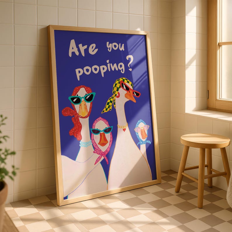 May include: A framed art print featuring three stylized geese wearing sunglasses and scarves against a dark blue background. The text "Are you pooping?" is written in white. The artwork is in a light wood frame.