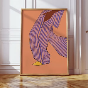 May include: An abstract art print showing a figure in striped purple and white trousers and a matching top. The artwork is set against a peach background and framed in a gold-coloured frame. The figure is wearing yellow shoes.