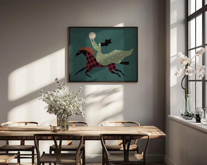 May include: A framed art print depicts a figure riding a horse across a teal background. The horse is red and black checkered, and the rider wears a green dress and holds a white orb. The artwork is displayed above a wooden dining table.