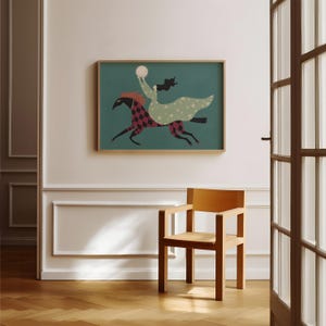 May include: A framed art print depicts a woman riding a horse, holding a moon. The horse has a red and black diamond pattern. The woman wears a green dress with stars. The background is teal.