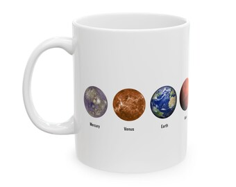 May include: White ceramic mug with a colorful illustration of the planets Mercury, Venus, Earth, and Mars. The planets are labeled with their names.