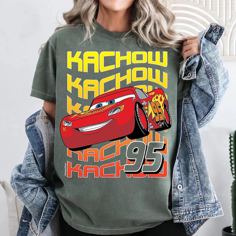 a woman wearing a green shirt with a cartoon character on it