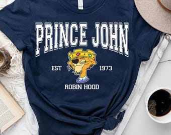Camiseta de colores cómodos del Príncipe Juan, personaje de Robin Hood; camiseta de los villanos de Disney, el Príncipe Juan, el falso rey de Inglaterra; camiseta de viaje a Disneyland (WDW)