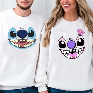 a man and a woman wearing matching sweatshirts