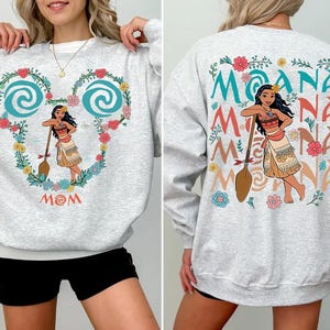 a woman wearing a moan moan sweatshirt and shorts