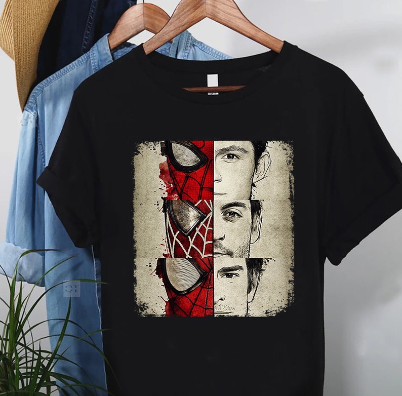a spider - man and spider - man t - shirt hanging on a clothes rack