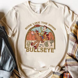 a t - shirt that says ride like the wind with an image of a cowboy