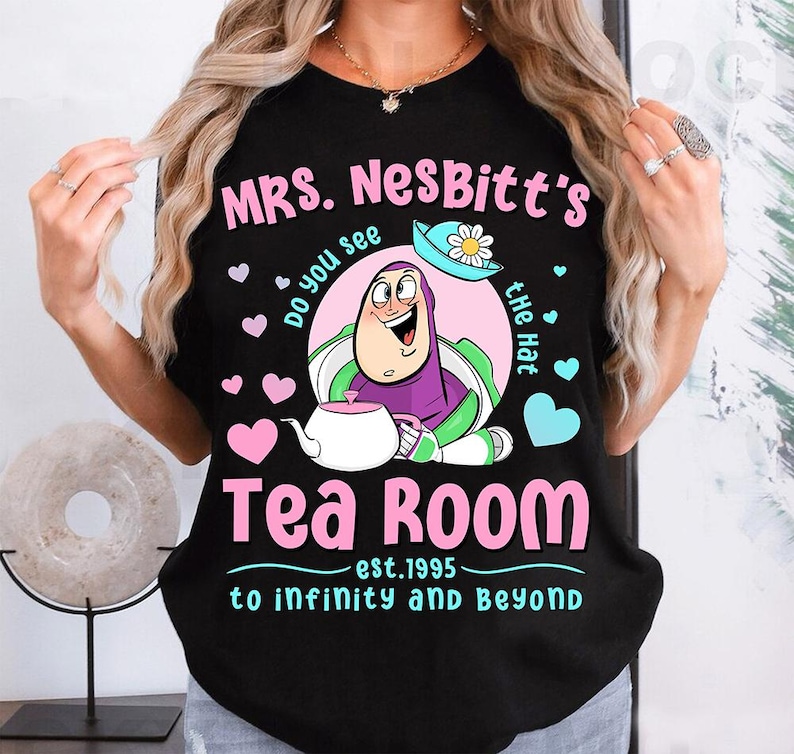 a woman holding up a t - shirt that says mrs nobitt's