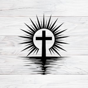 May include: A black cross silhouette with a radiant sunburst design, reflected in a body of water. The image is set against a white, wood-grain background, creating a stark contrast.