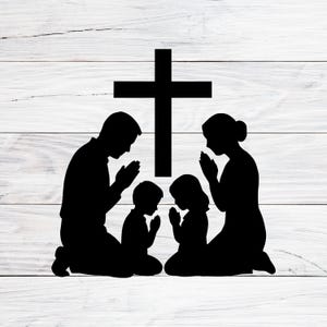 May include: Black silhouette of a family praying, kneeling with hands clasped, in front of a large cross. The image is set against a white wood-grain background, creating a stark contrast.