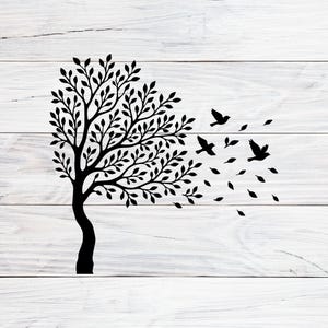 May include: Black silhouette of a tree with leaves and birds on a white wooden background. The tree's branches and leaves are blowing in the wind, with birds and leaves also being blown away. The image is a simple, elegant design.