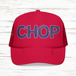 May include: A red trucker hat with the word "CHOP" in blue denim-style lettering across the front. The hat has a mesh back and a curved brim. The hat is a vibrant red color.
