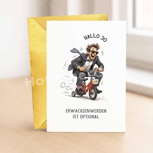 May include: A greeting card with a cartoon illustration of a man riding a red tricycle. The man wears a suit and sunglasses. Text on the card reads "Hallo 30" and "Erwachsenwerden ist optional."