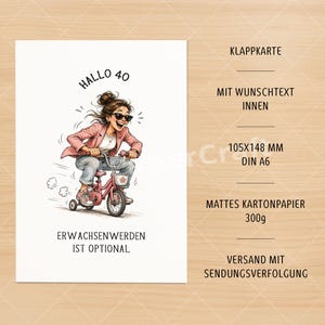 May include: A white greeting card with a cartoon illustration of a woman riding a pink tricycle. The card has the text "Hallo 40" and "Erwachsenwerden ist optional". The card measures 4.1 x 5.8 inches.