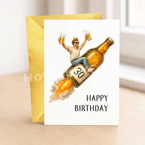 May include: A birthday card with a gold envelope. The card features a man riding a beer bottle rocket, holding two mugs of beer, and wearing a crown. The number "30" is on the bottle, and the words "HAPPY BIRTHDAY" are below.