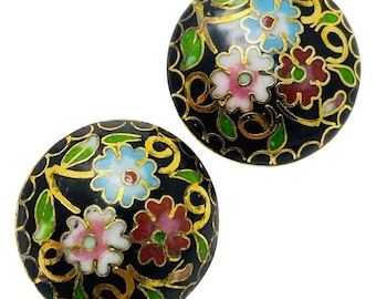 May include: Pair of round, black cloisonné earrings with floral designs. Each earring features a black background with gold-colored swirls and colorful flowers in pink, blue, and red, with green leaves.