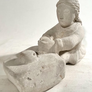 Woman at grinding stone by Ludwik Szczepaniak
