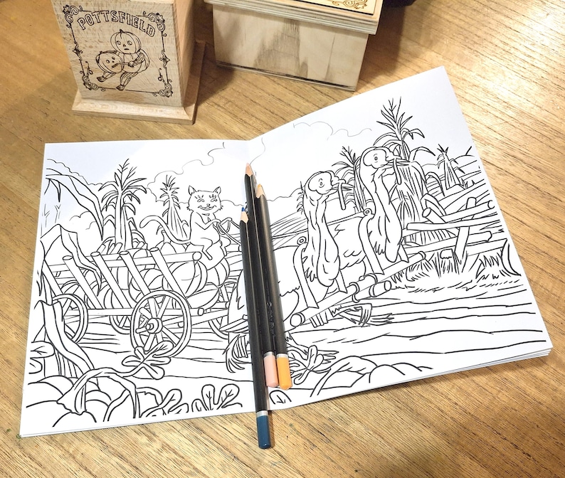 May include: A black and white coloring page featuring a cat pulling a wagon full of pumpkins and two birds perched on a fence.