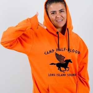 May include: Orange hoodie with a black Camp Half-Blood logo featuring a winged horse and the text "Long Island Sound".