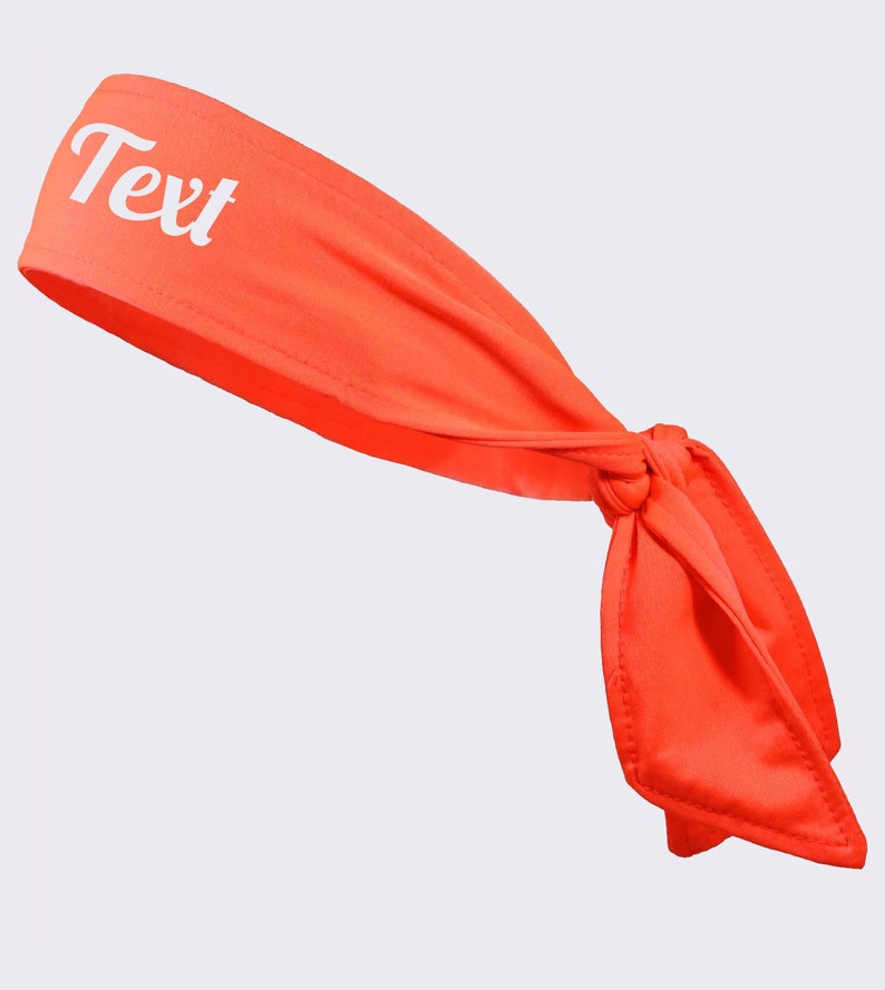 May include: A bright orange headband with a white "Text" inscription. The headband is tied in a knot at the back.